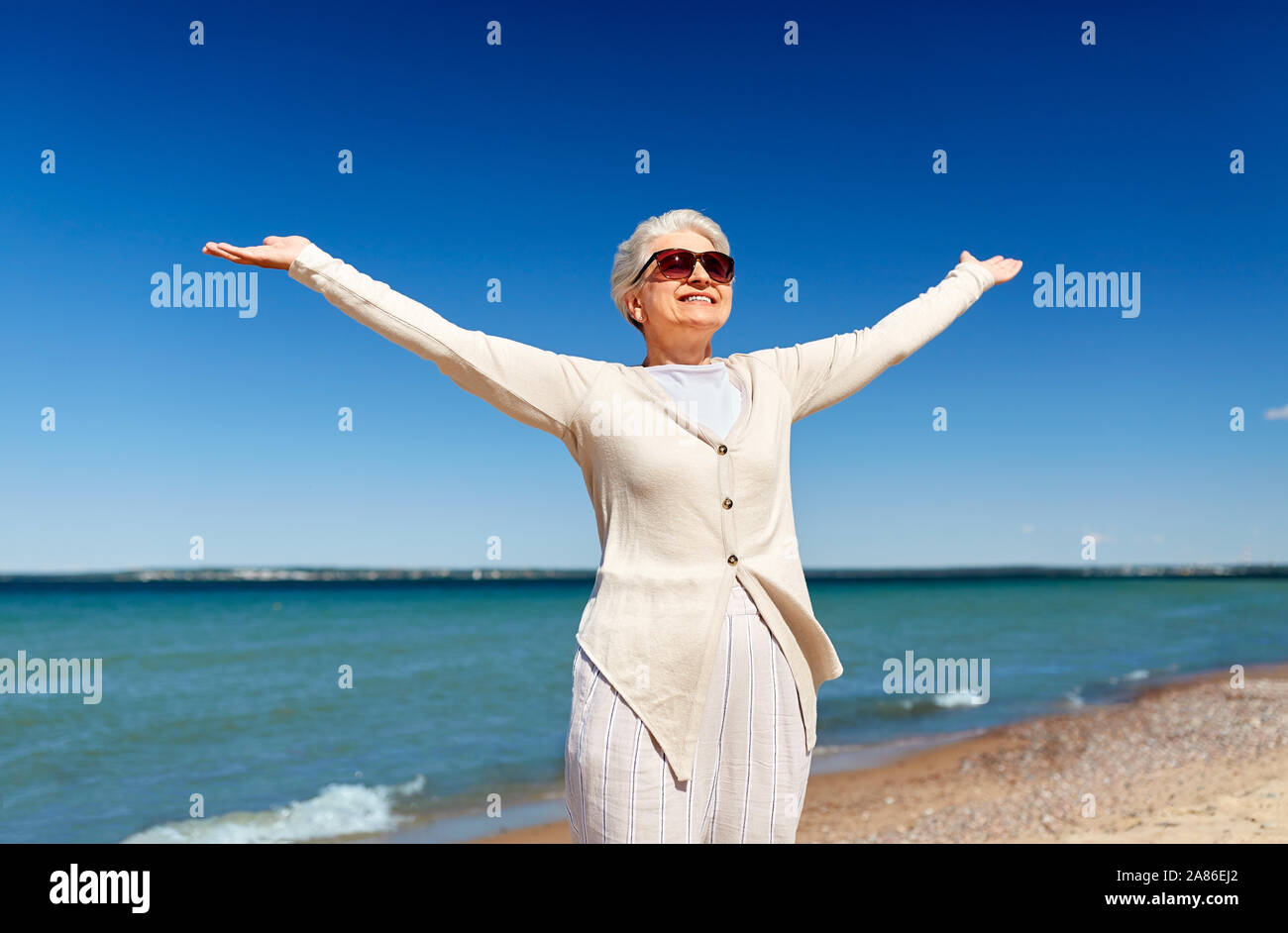 portrait of senior woman in sunglasses on beach Stock Photo - Alamy
