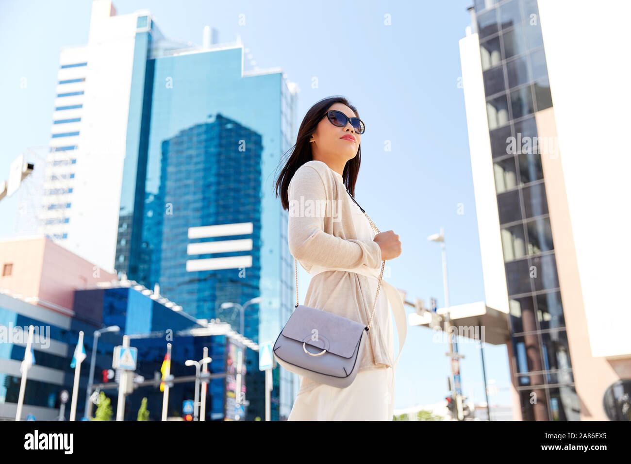 happy smiling young woman on city street Stock Photo - Alamy