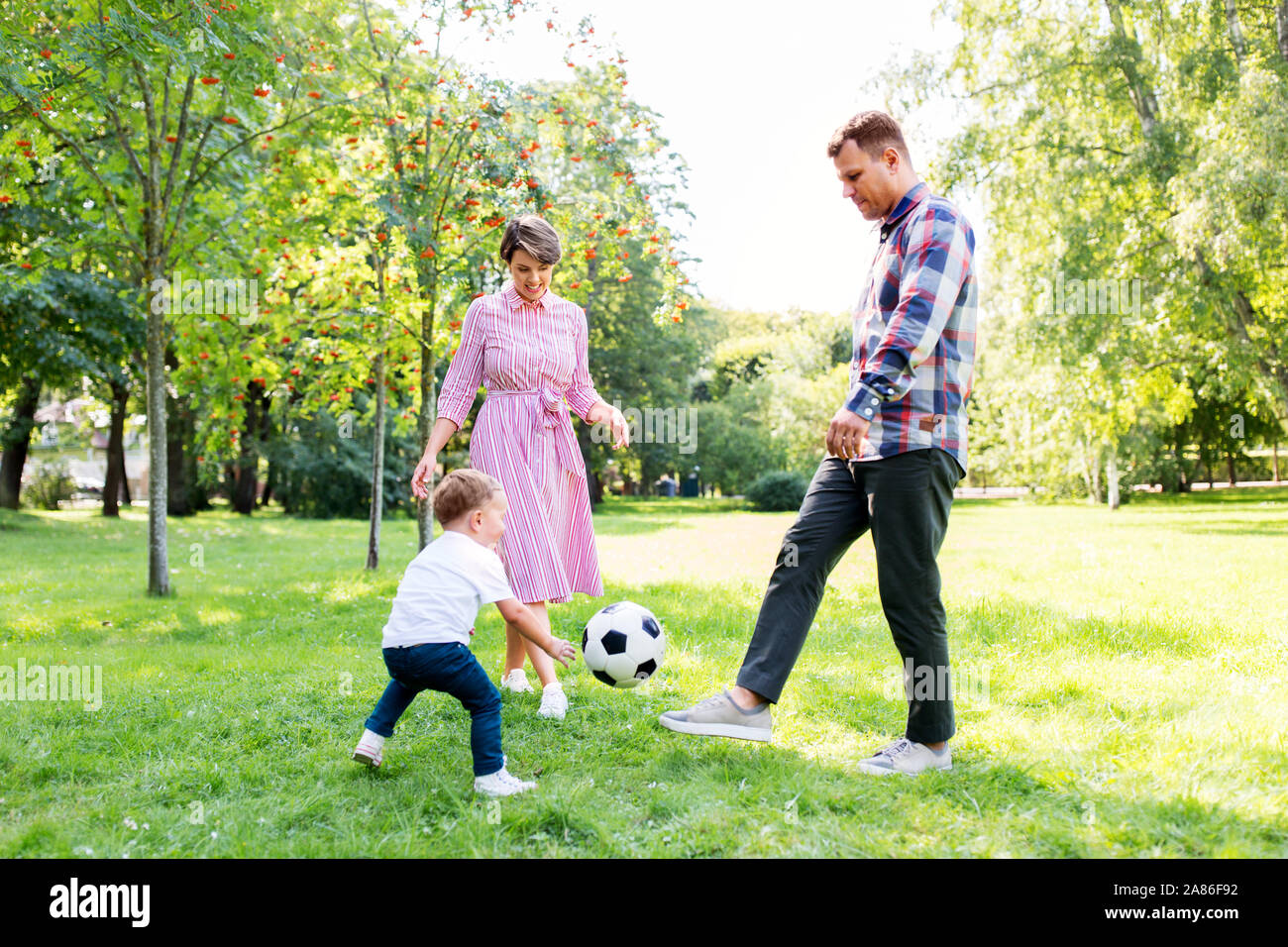 happy family playing soccer at summer park Stock Photo - Alamy