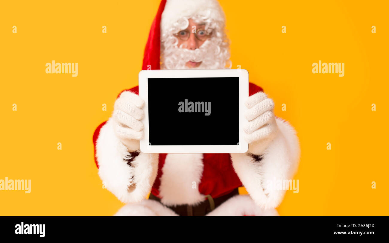 Santa Claus surprisingly showing new tablet with blank screen Stock ...