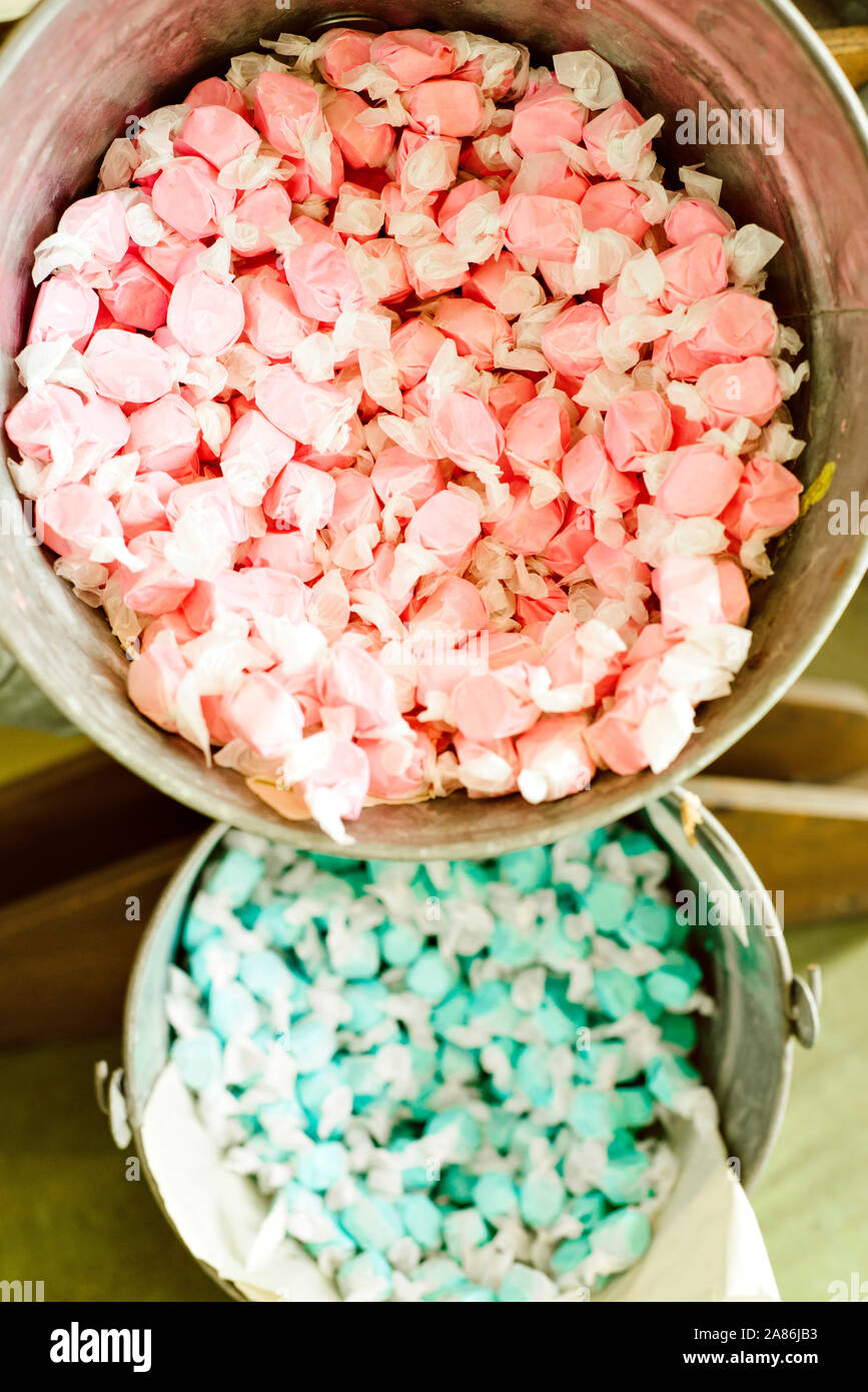 Colorful salt water taffy candy in aluminum buckets for sale Stock