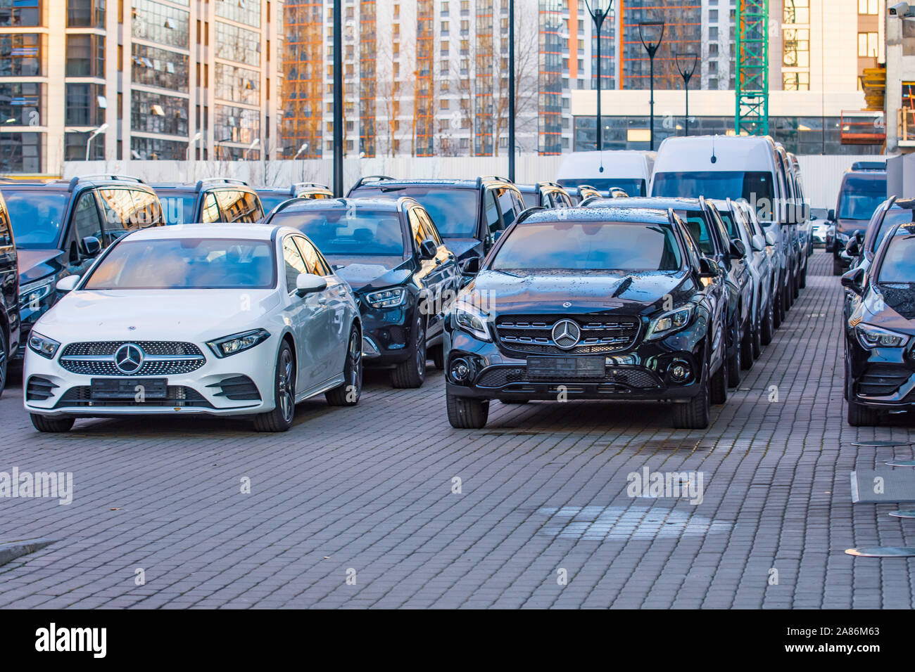 Luxury cars Mercedes-Benz C and E class parkingin a row of car store. View of the sign symbol, front bumper. Russia. Saint-Petersburg. 28 October 2019 Stock Photo