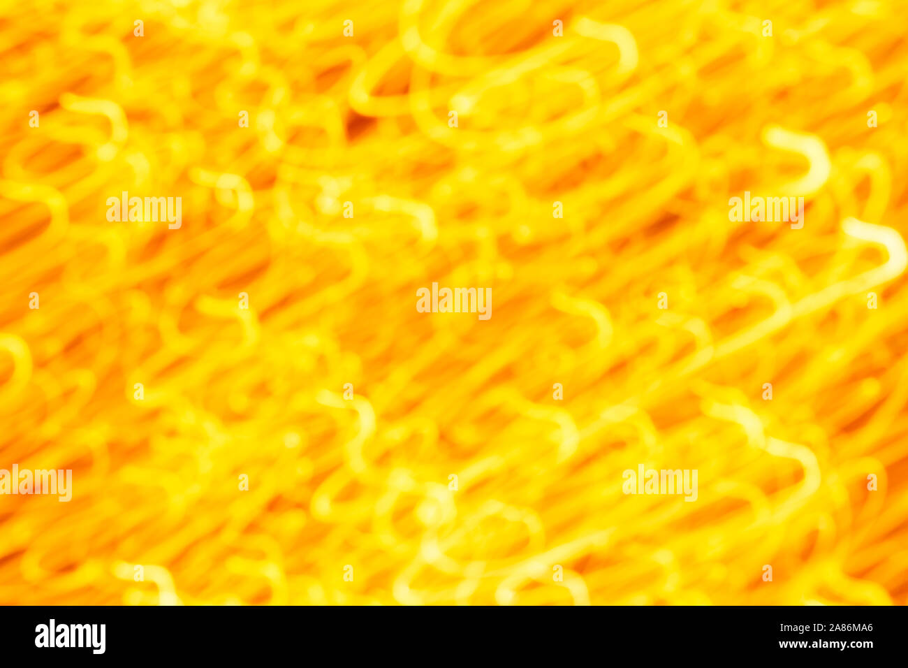 Futuristic blurred lights holiday monochrome background in yellow. Horizontal, soft focus Stock Photo