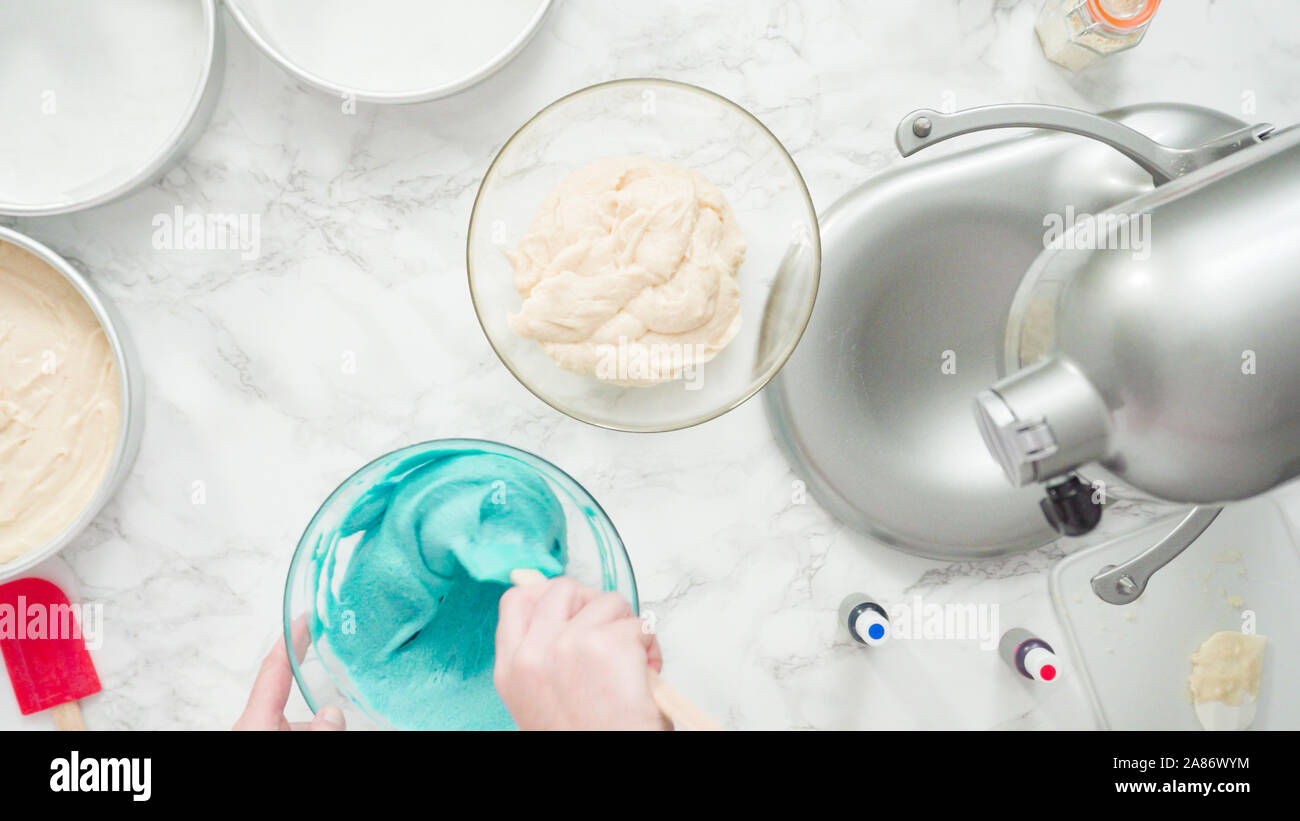 Step by step. Flat lay. Mixing food coloring into a cake batter to bake ...