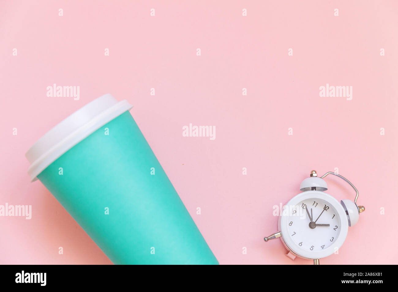 Simply flat lay design blue paper coffee cup and alarm clock isolated ...