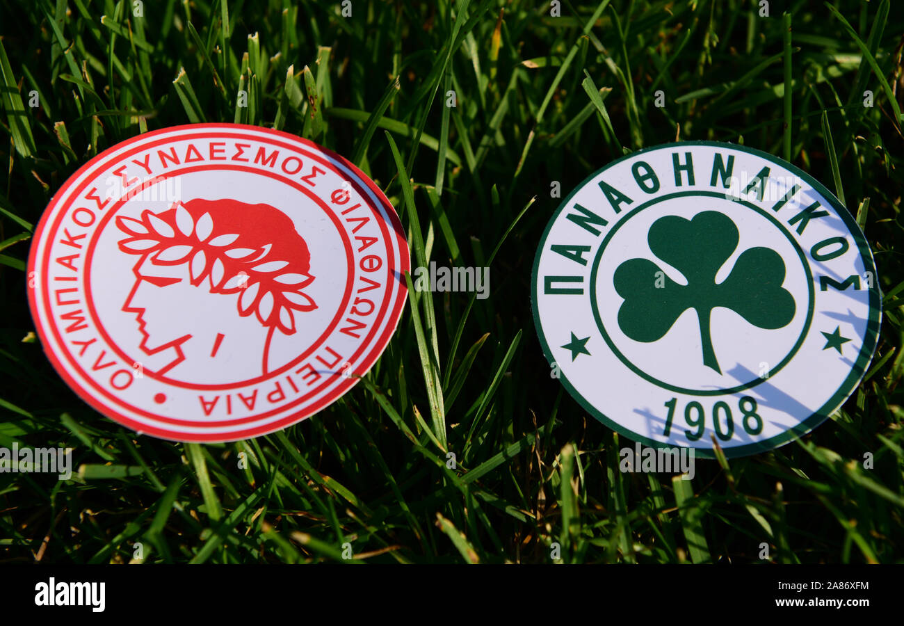 September 6, 2019 Athens, Greece The emblems of the Greek football clubs Panathinaikos Athens and Olympiacos Piraeus on the green grass of the footbal Stock Photo