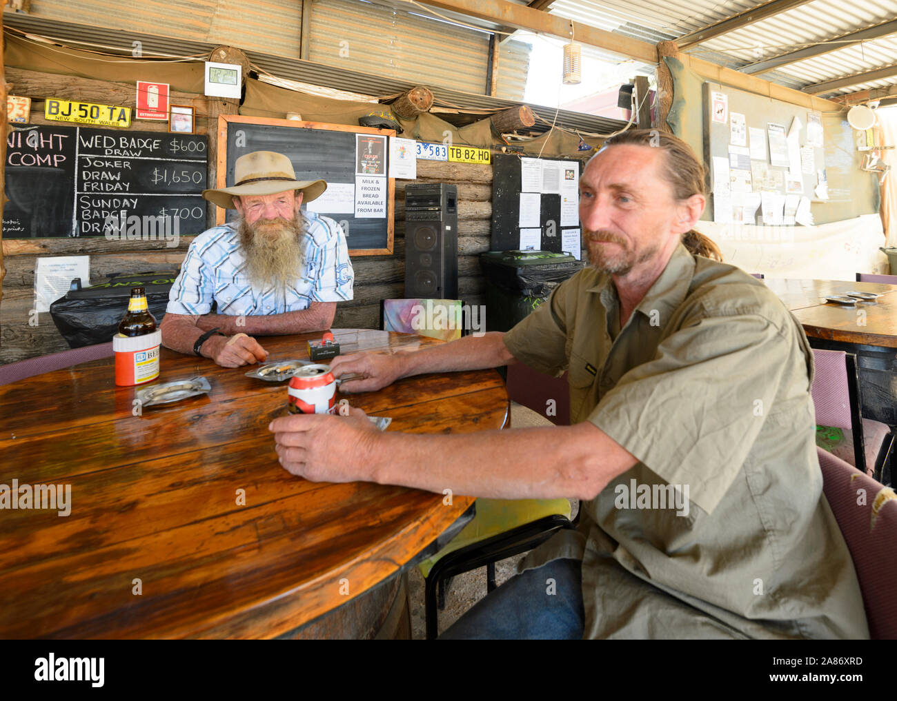 Opal miners sitting outside the iconic Club in the Scrub, the Grawin, Queensland, QLD, Australia Stock Photo