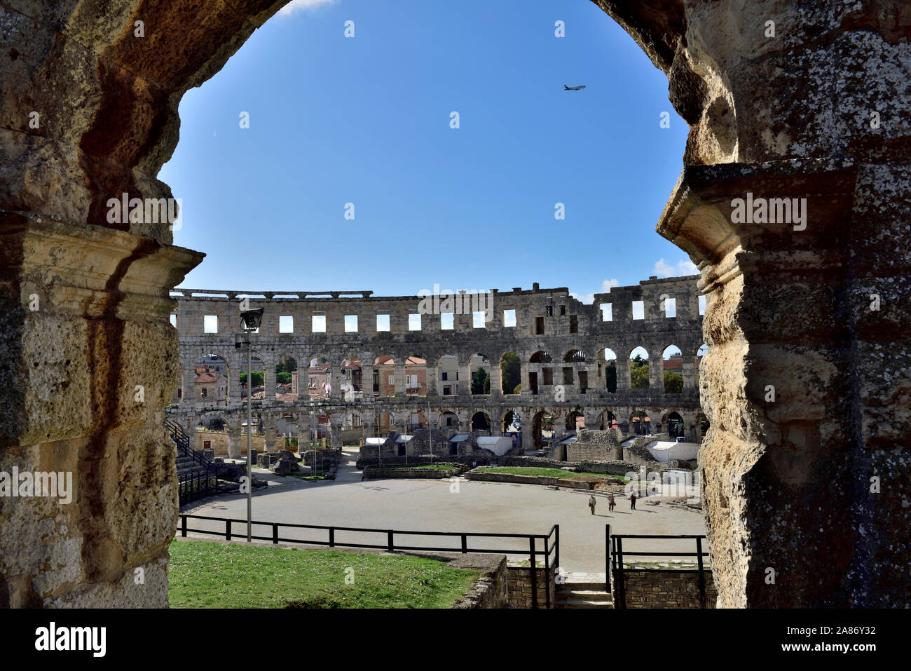 Ancient Pula Roman amphitheatre in the city centre, looking through archway, Croatia Stock Photo