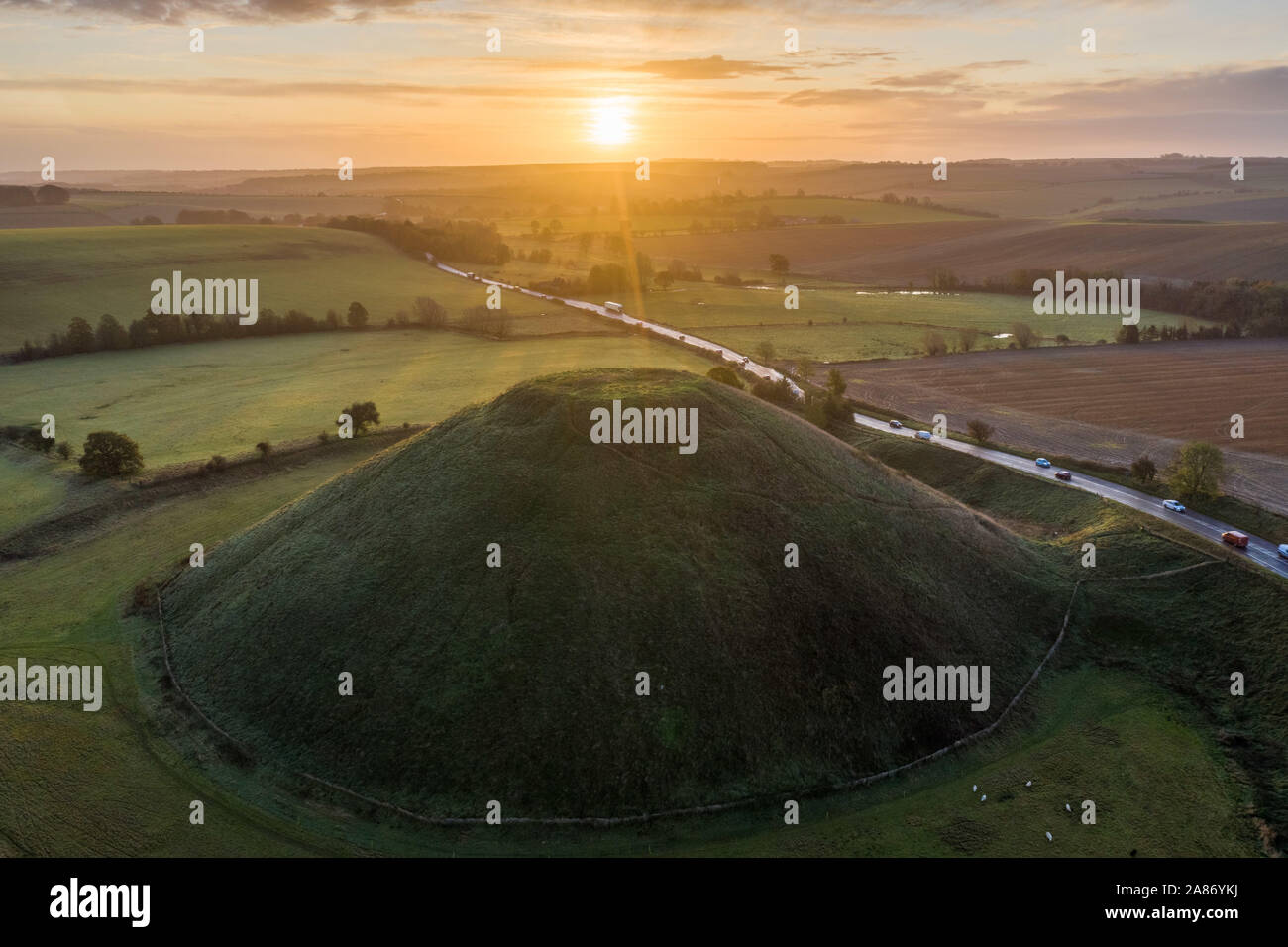 Silbury Hill, Nr Avebury, Wiltshire, UK. 4th November 2019. Drone image the sunrise above the neolithic mound of Silbury Hill in Wiltshire. Stock Photo