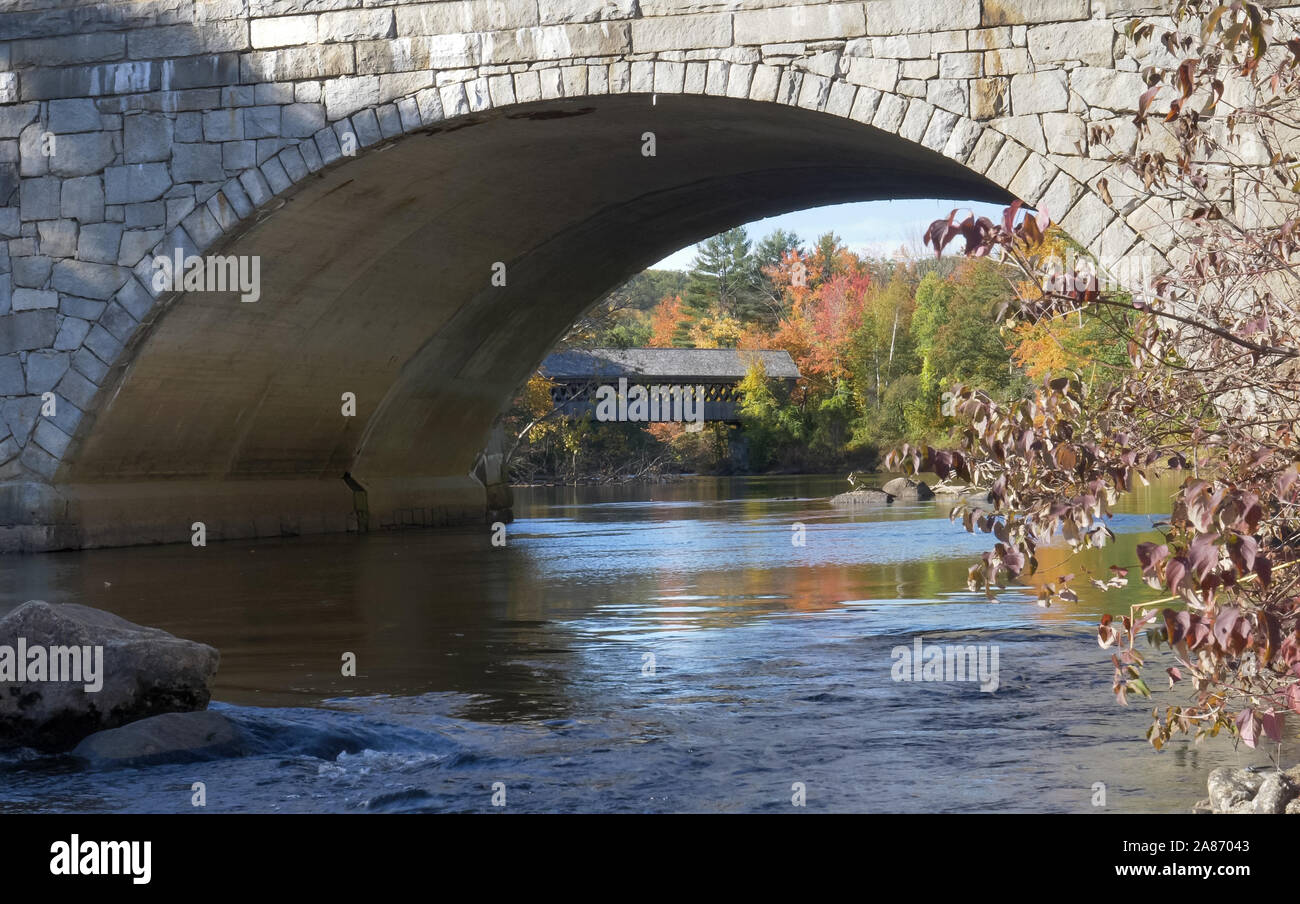 henniker covered bridge in new hampshire with trees in fall thru