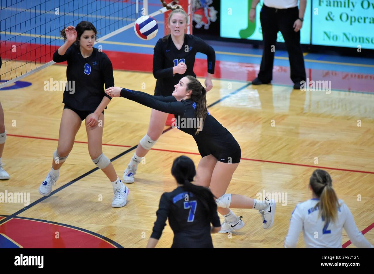 Player straining to keep a volley alive during a prolonged volley. USA. Stock Photo