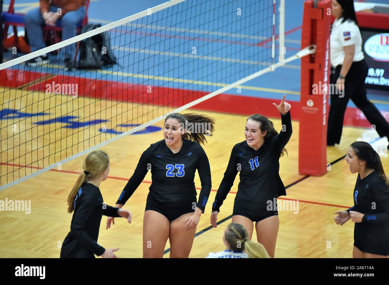Teammates react and celebrate a hard earned point in a volleyball playoff match. USA. Stock Photo