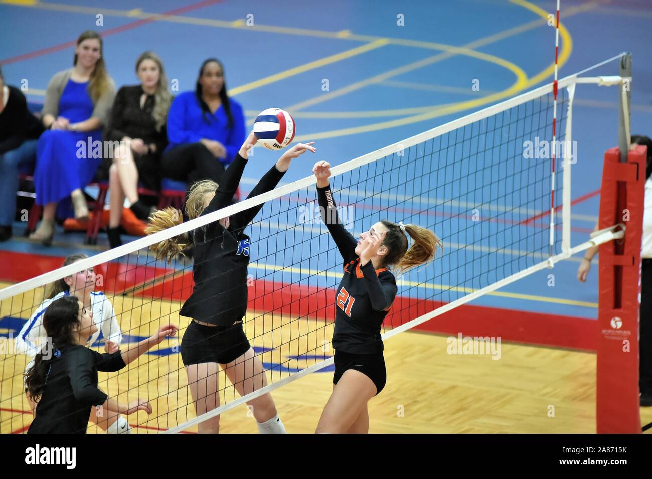Player attempting to deliver a kill shot past an opponent trying to block the effort. USA. Stock Photo