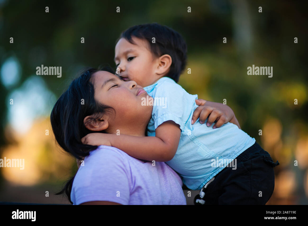 Siblings hug and embrace each other showing love, and affection, expressing that they will stand by each other. Stock Photo