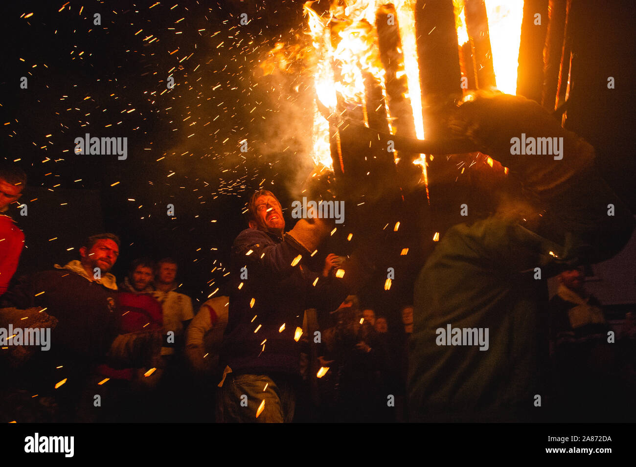 Ottery St Mary, UK, 5th Nov 2019, Participants take part in the Ottery St Mary Tar Barrels event to celebrate the 5th of November by carrying burning barrels up and down the street. Credit: Guy Peterson/ Alamy Live News Stock Photo