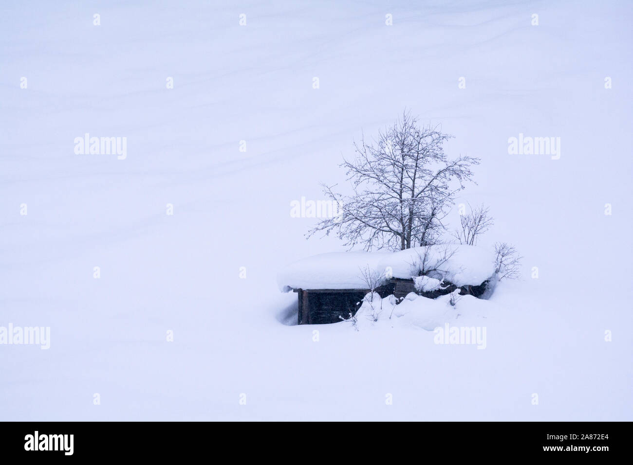 Isolated Wooden hut in winter time.Kaunertal valley in Tyrol, in the Austrian Alps. Massive snow falls are covering this area in winter. Stock Photo