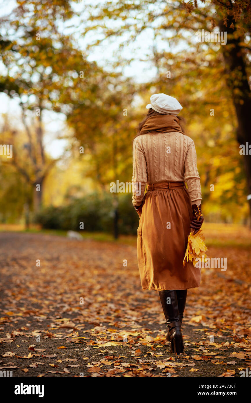 Girl in a knitted hat and scarf on a background of autumn …