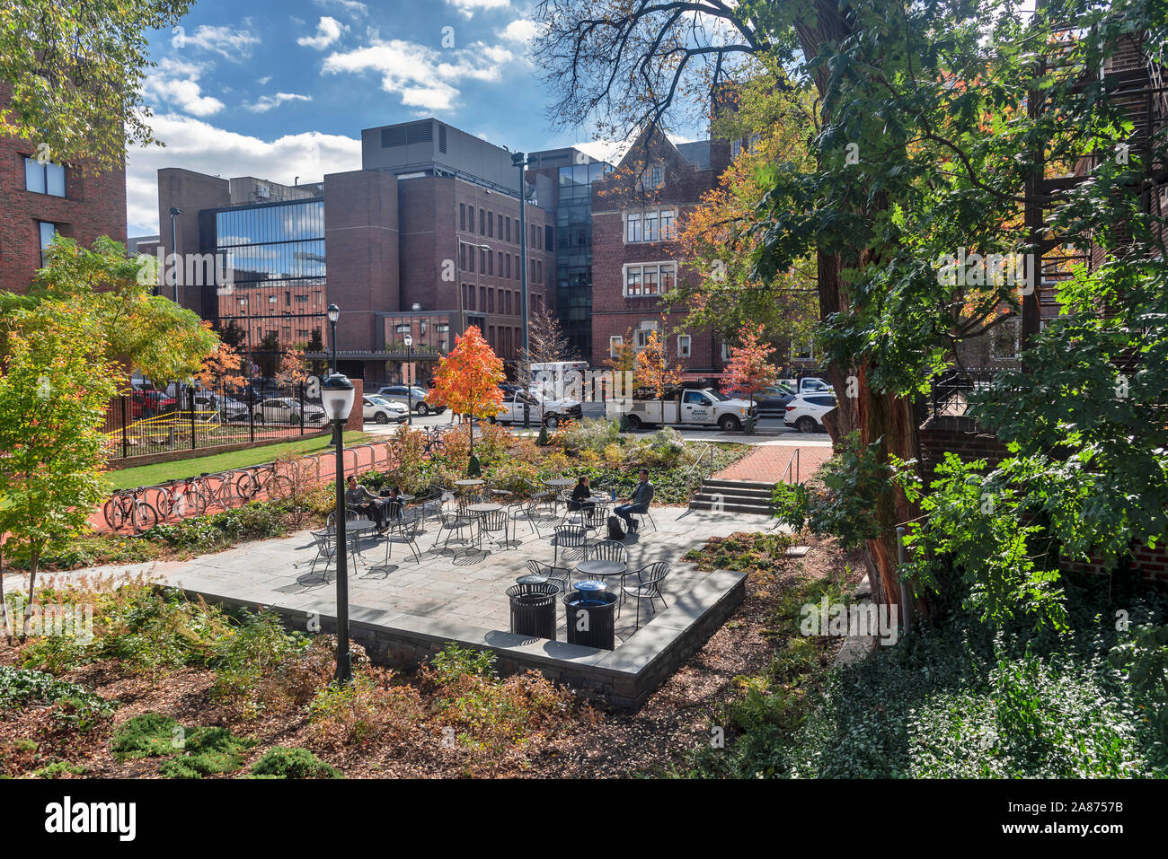 A couple sits at a table in an outdoor cafe and drinks coffee