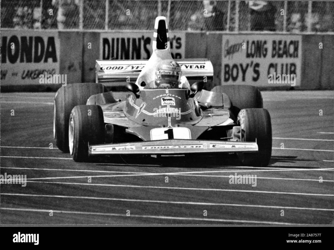 Niki Lauda in his Ferrari 312T2 at the Long Beach Grand Prix - The United States Grand Prix of 1977.   Andreas Nikolaus Lauda was an Austrian Formula One driver, a three-time F1 World Drivers' Champion, winning in 1975, 1977 and 1984, and an aviation entrepreneur. He is the only driver in F1 history to have been champion for both Ferrari and McLaren, the sport's two most successful constructors. 22 February 1949 – 20 May 2019) was an Austrian Formula One driver, a three-time F1 World Drivers' Champion, winning in 1975, 1977 and 1984, and an aviation entrepreneur. He is the only driver in F1 hi Stock Photo