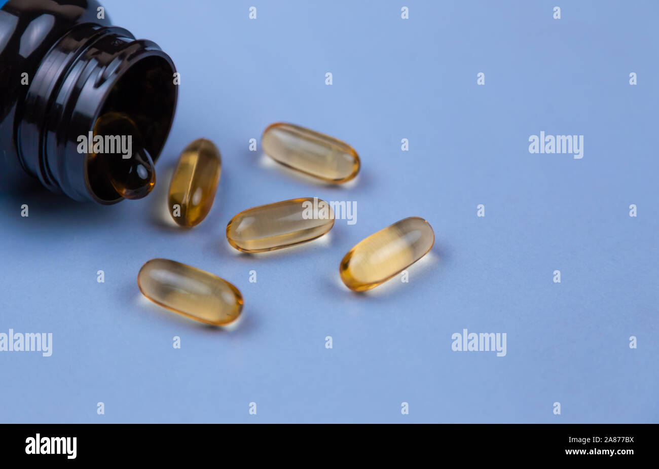 Brown gel capsule pills spread out of drug bottle. Antipsychotic drug. Capsule medicine for