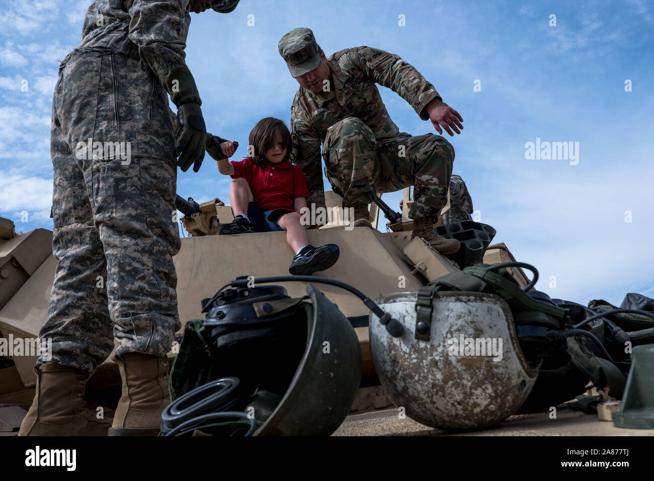 El Paso, Texas, USA. 6th Nov, 2019. HUNTER OBERLE, 4, center, follows his father CPT. RAYMOND OBERLE, right, of the 3rd Armored Brigade Combat Team, 1st Armored Division, as they make their way off an M1A2 Abrams Rank on display during the celebration of Torch Week at Fort Bliss in El Paso, Texas. The celebration commemorates the United States' invasion of North Africa during Operation Torch on November 8 through November 16, 1942 during World War II. Credit: Joel Angel Juarez/ZUMA Wire/Alamy Live News Stock Photo