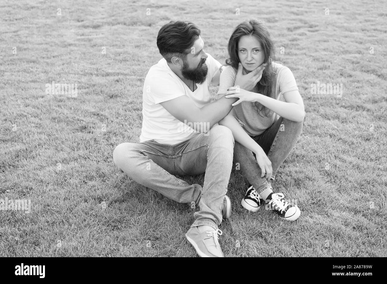 Simple happiness. Couple relations goals. Playful girlfriend and boyfriend dating. Summer vacation. Lovely couple outdoors. Couple spend time in nature. Couple in love relaxing on green lawn. Stock Photo