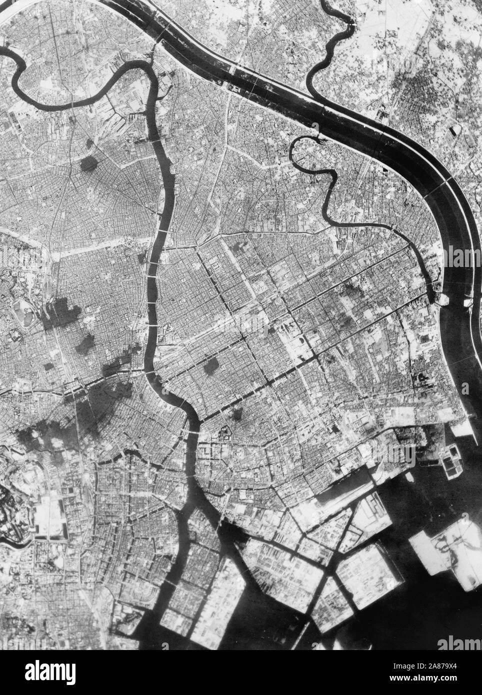 Aerial photo of Tokyo showing effects of first large-scale incendiary bombing attack by U.S. 20th Air Force operations. 1945 Stock Photo