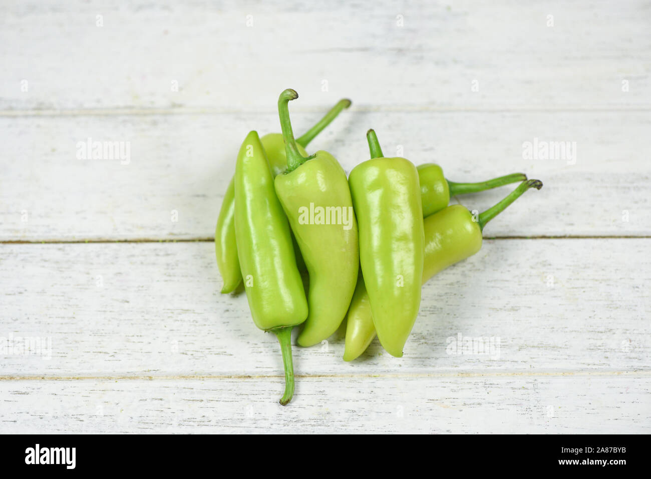 Fresh banana peppers or sweet pepper green garden on a white wooden