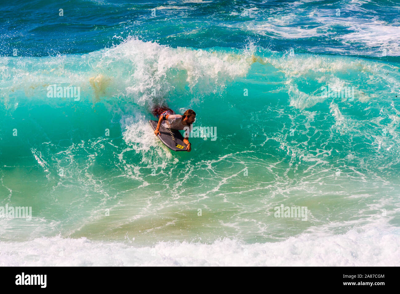 Sydney, Australia - March 16th 2013: Man surfing on a wave. The sport is very poular. Stock Photo