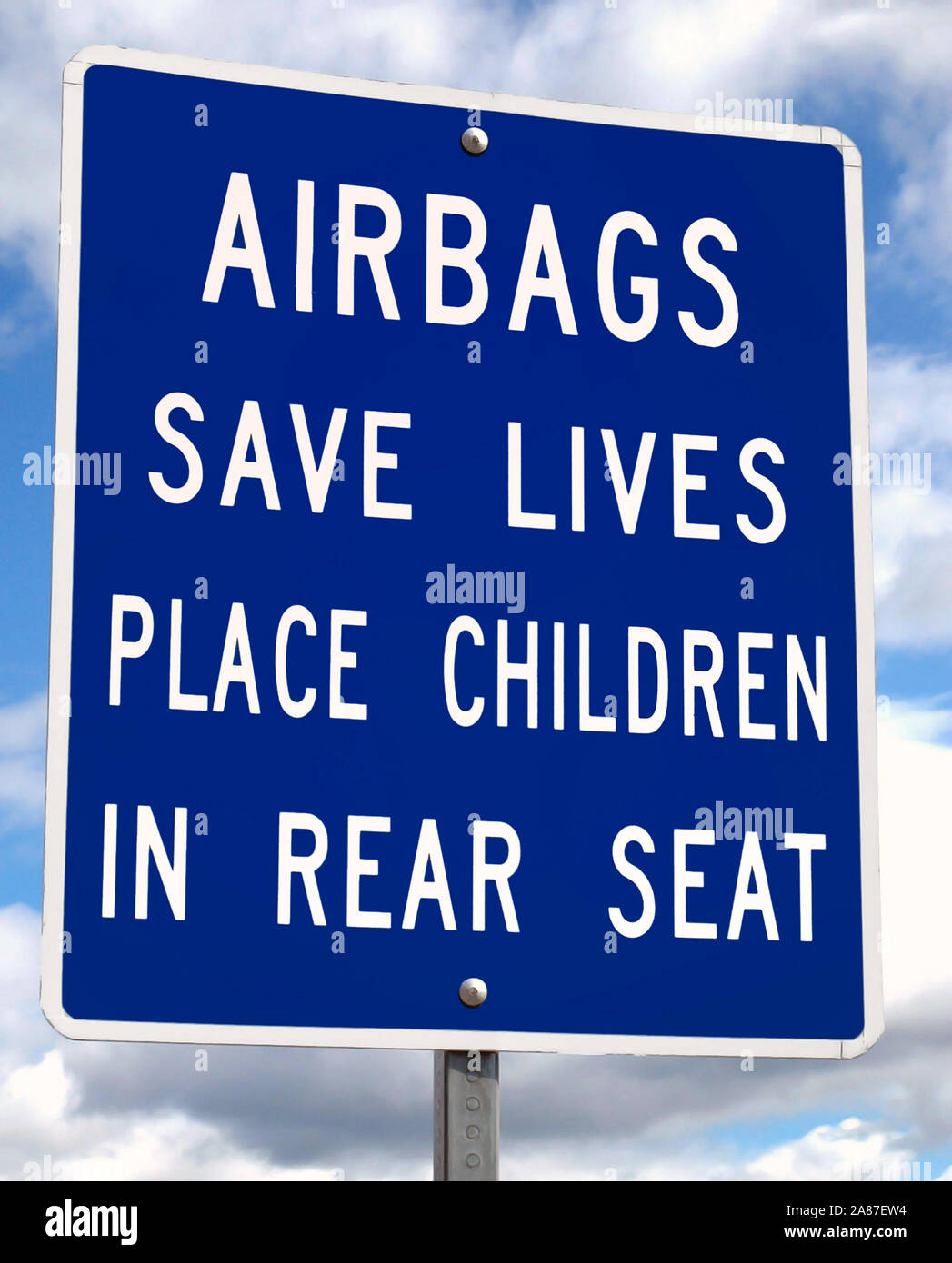 Airbag safety message on sign advises that children should be in rear