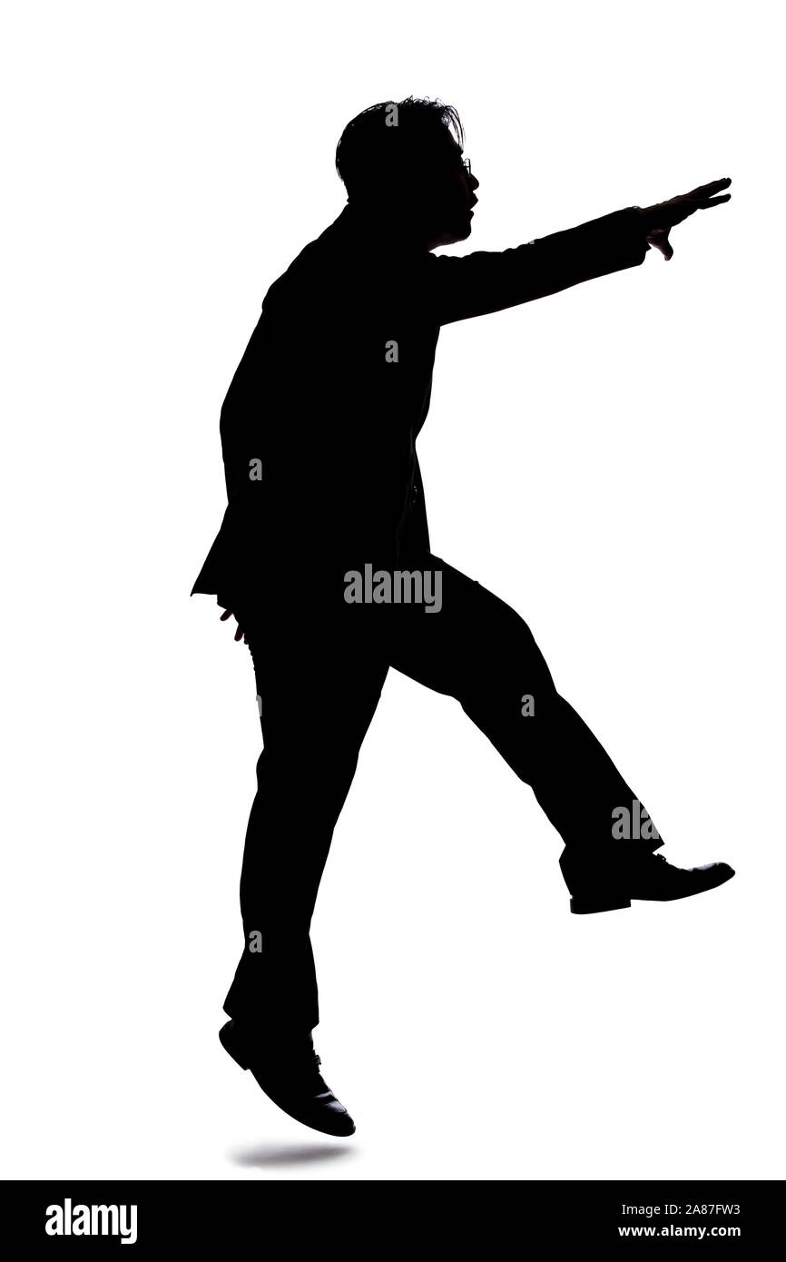 Silhouette of a backlit model posing as a businessman on a white