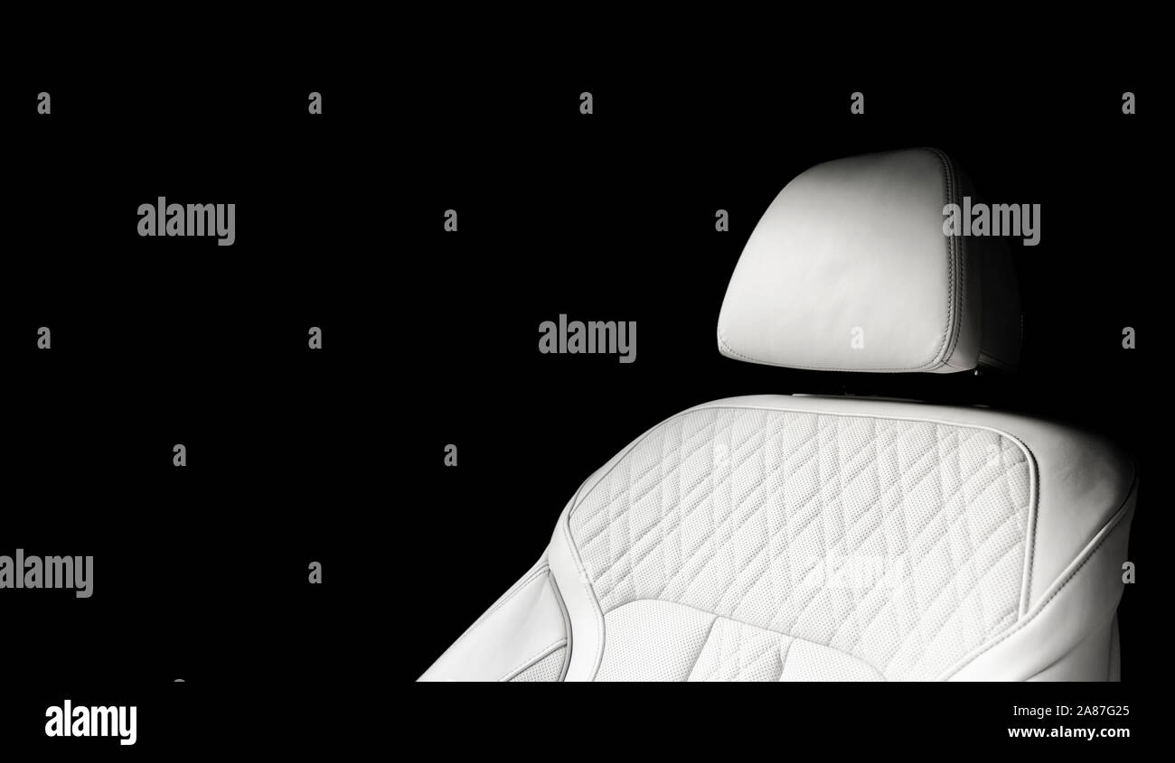 White leather interior of the luxury modern car. Perforated white leather comfortable seats with
