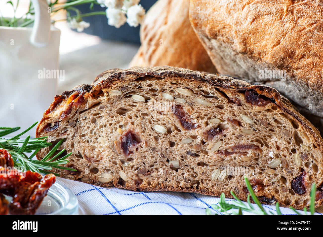Freshly baked rye bread with seeds and raisins on sourdough without yeast  with dried tomatoes rosemary and thyme. Homemade cake Stock Photo - Alamy