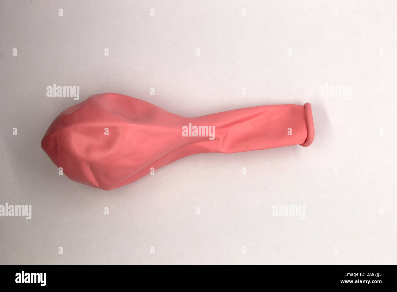 This is a photograph of a Pink Balloon isolated on a White background ...