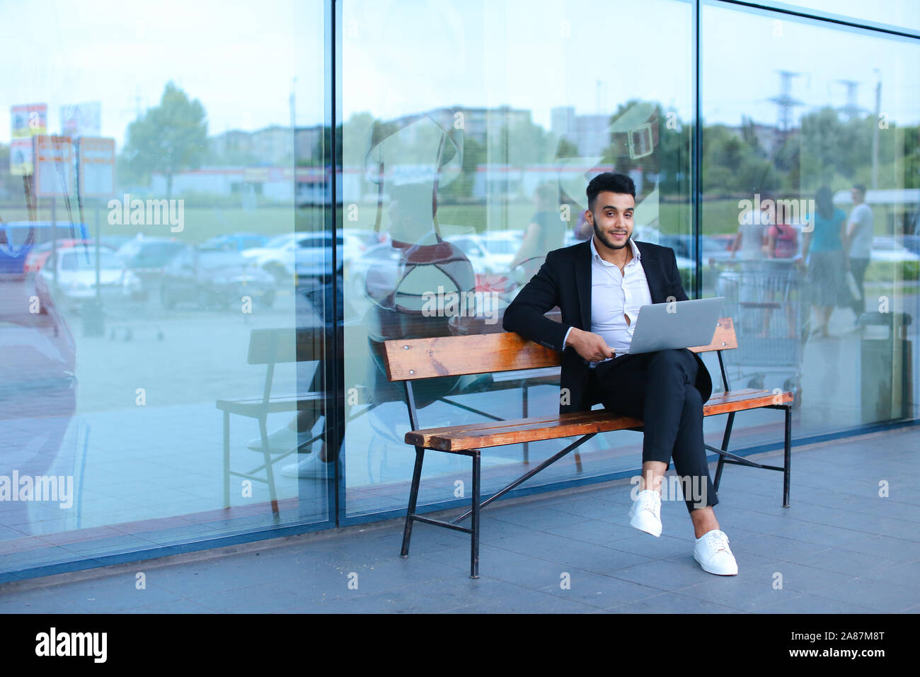 Cool guy arabic man uses laptop business center Stock Photo