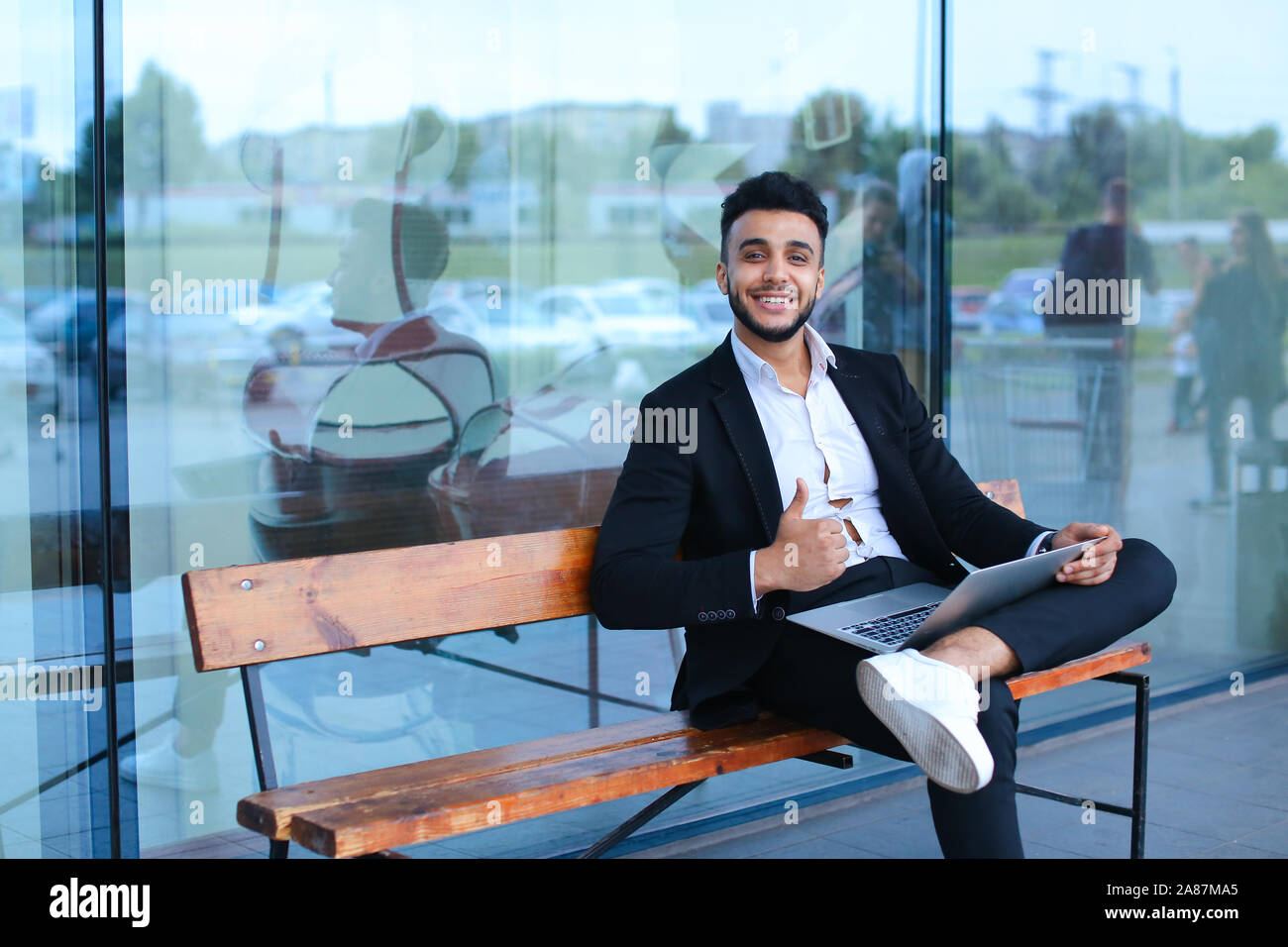 Cool guy arabic man uses laptop business center Stock Photo