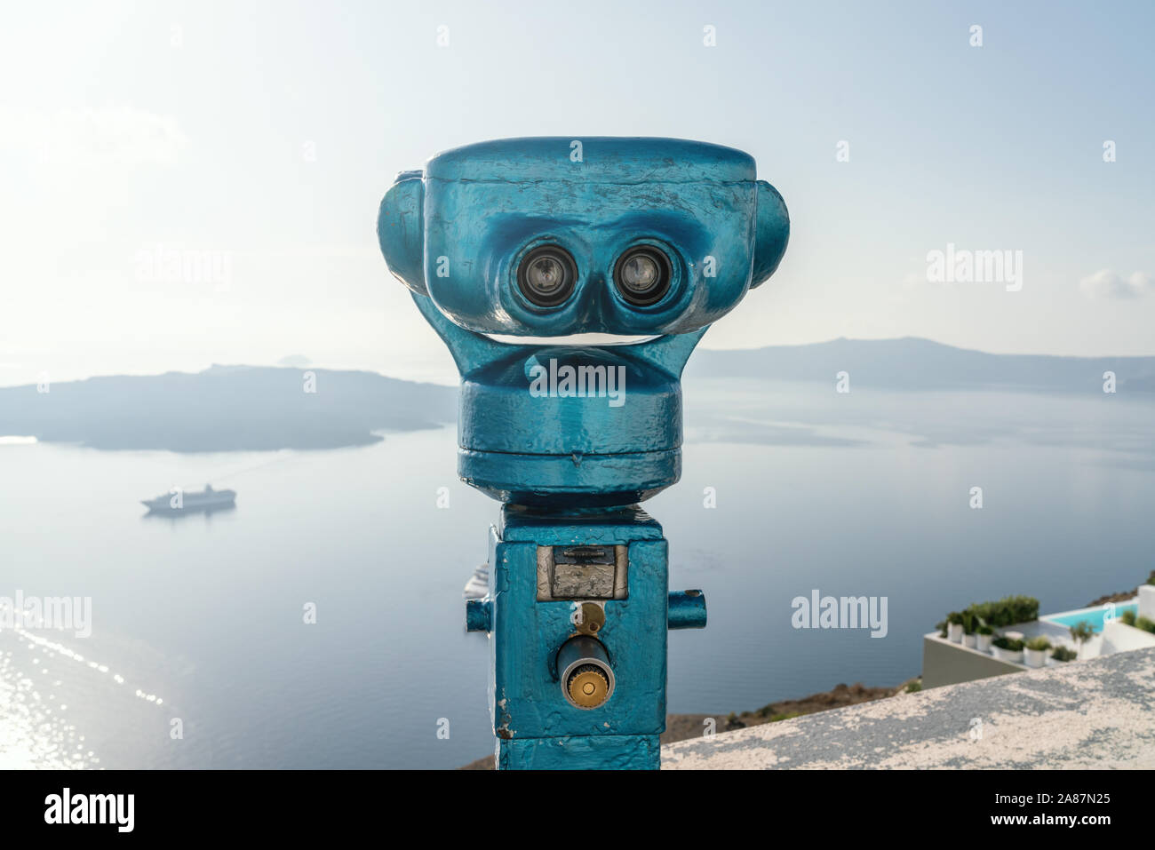 Old coin-operated binoculars in Fira, the capital town of Santorini overviewing the Agean Sea. Stock Photo