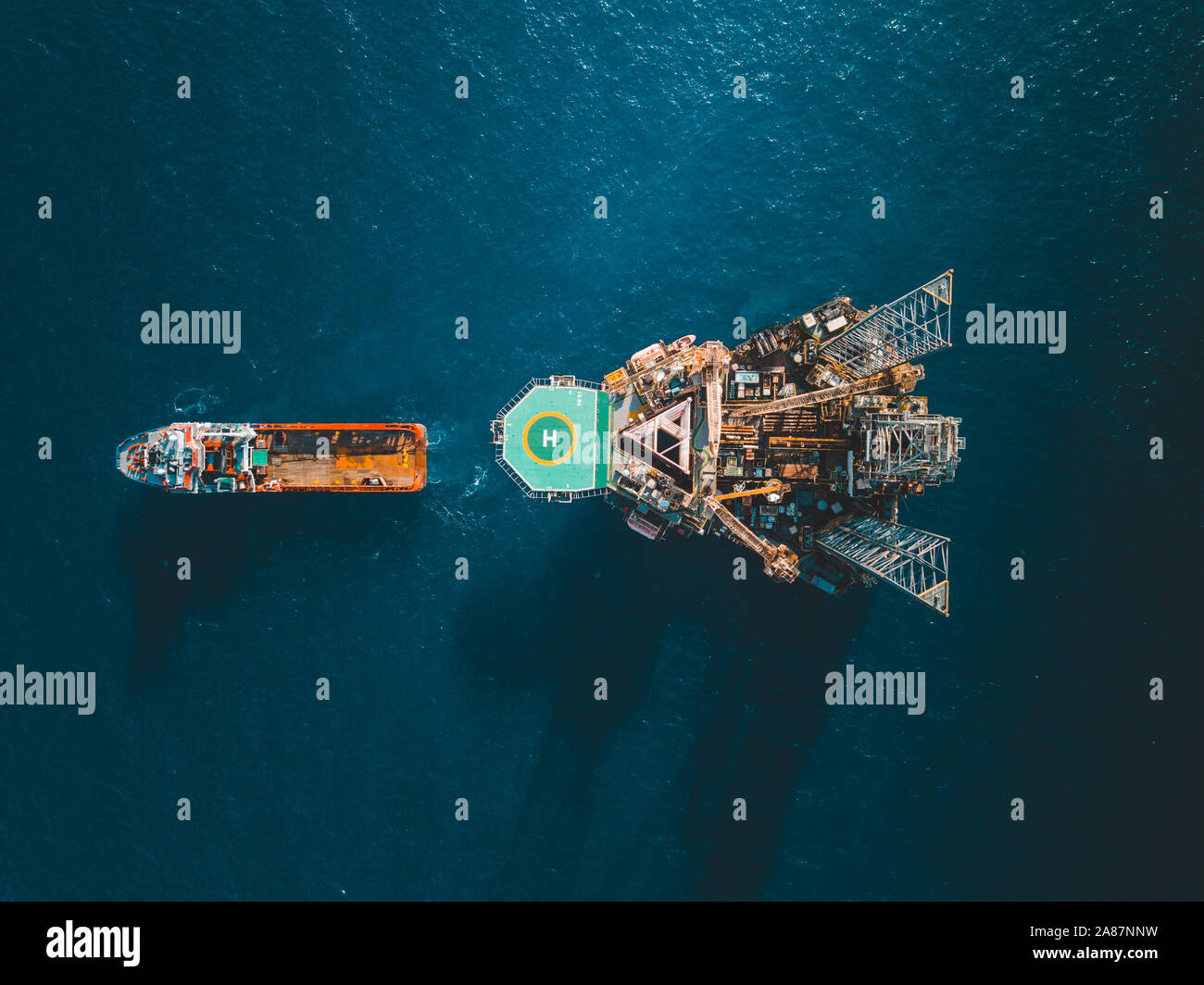 Aerial view of towing vessel engaged in towing operation of drilling rig Stock Photo