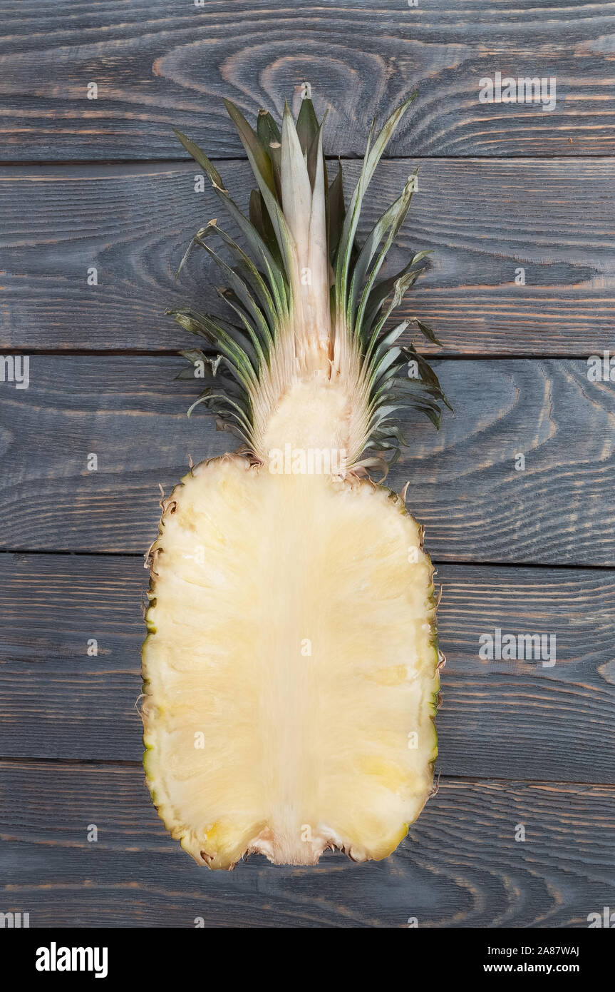 Flat lay of pineapple cut in half. White wooden table. Top view, overhead Stock Photo