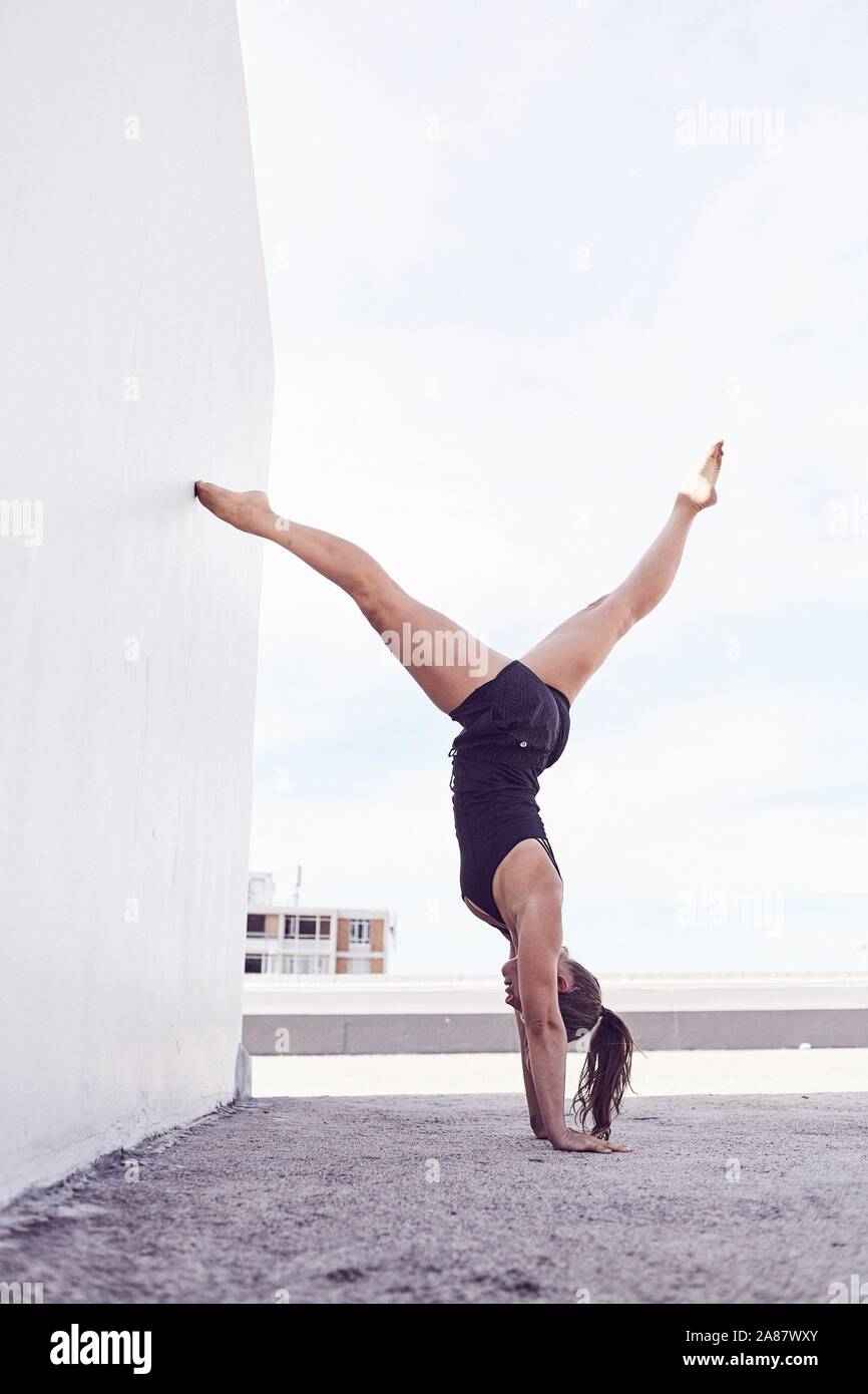 Young woman in swimsuit, handstand, gymnastics, Cape Town, South Africa