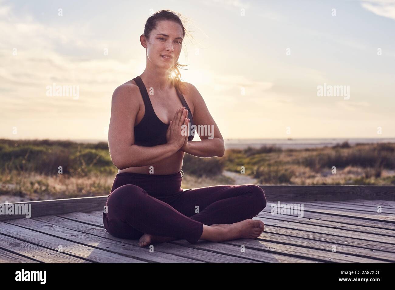 Young woman, yoga, gymnastics on the beach, Cape Town, South Africa