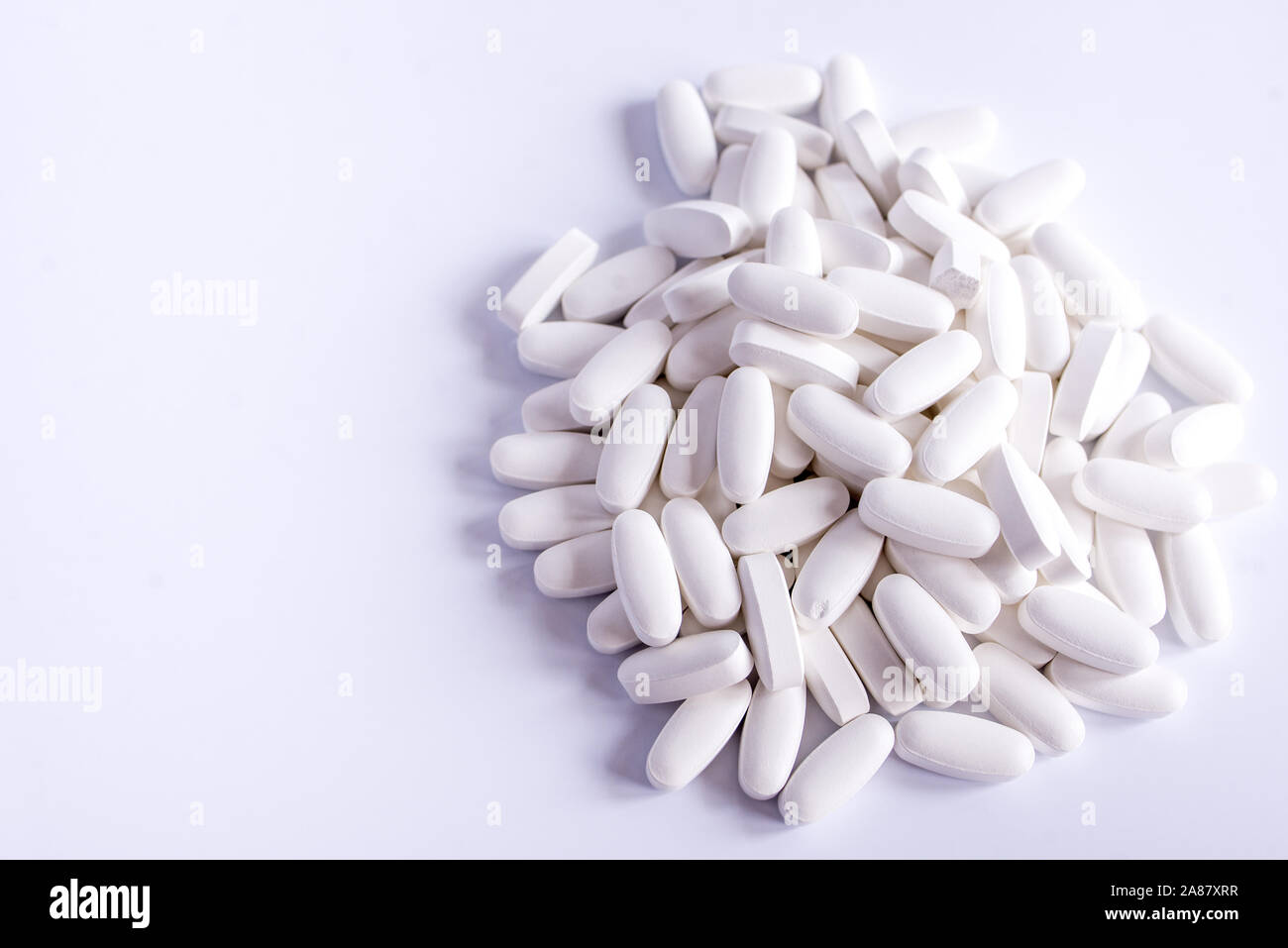 white pills on black background Stock Photo