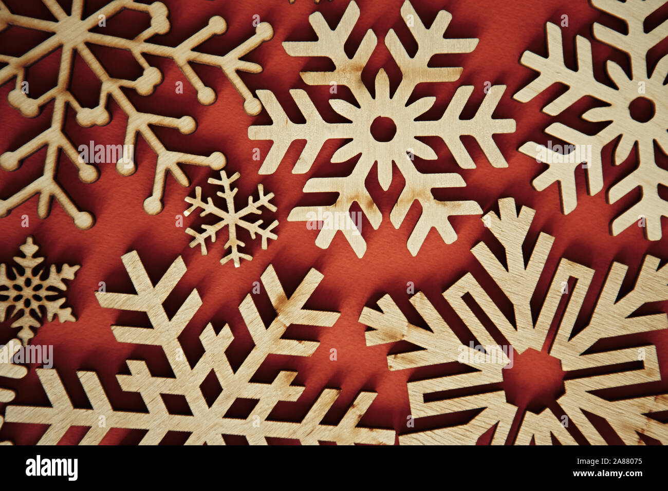 Christmas red background with wooden rustic snowflakes.Handmade crafts ...
