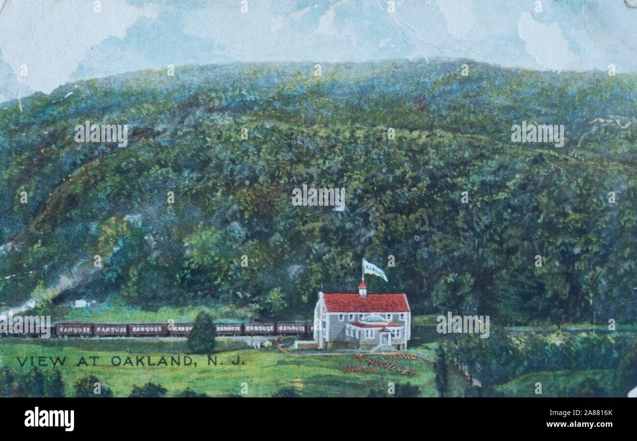 Vintage postcard with the home of Kanouse spring water, Oakland New Jersey USA, with a passing train, posted in 1910 Stock Photo
