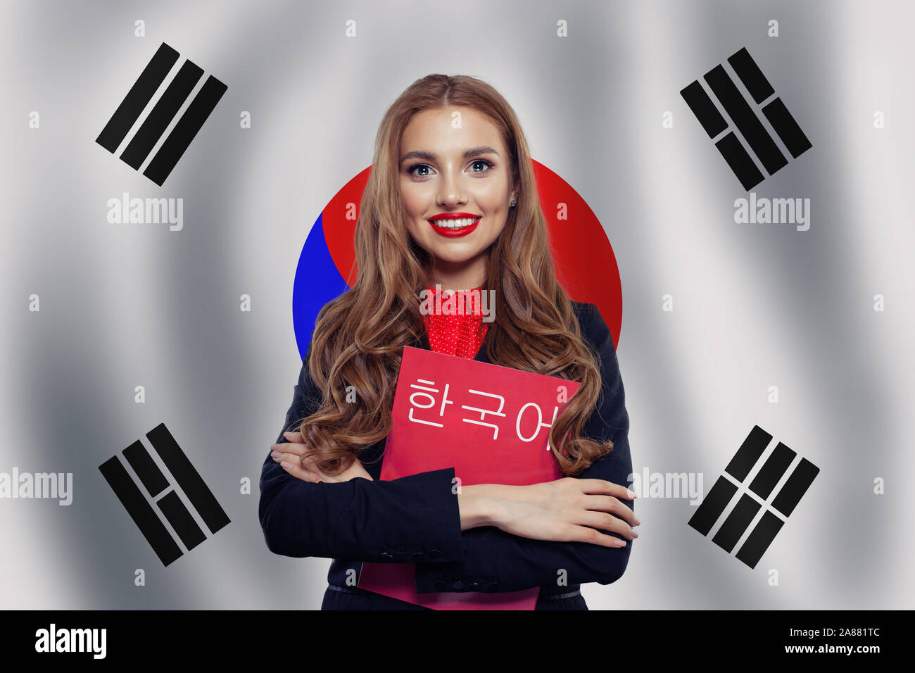 Study korean language. Happy cheerful woman student on the Republic of Korea flag background. Korean language school concept. Book with inscription Ko Stock Photo
