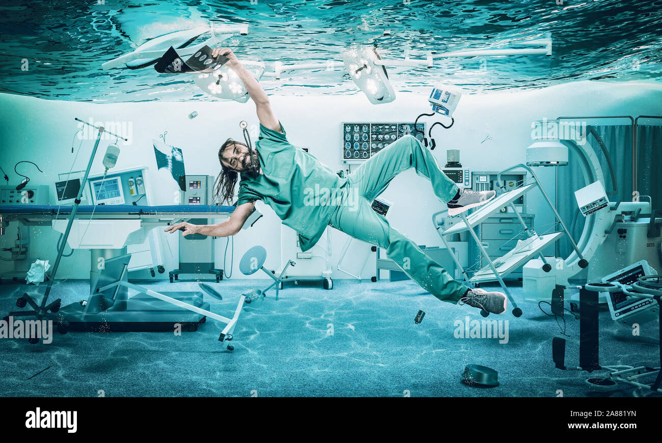 Smiling doctor floats under water in a flooded operating room. problems at work and in the medical field. Stock Photo