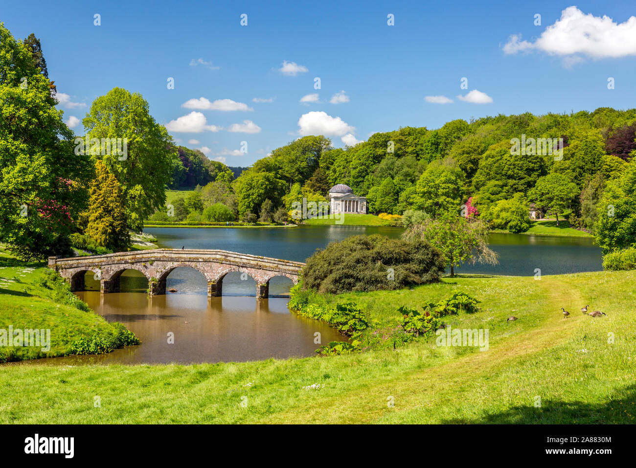 Looking across the lake with its Palladian Bridge towards the Pantheon at Stourhead Gardens, Wiltshire, England, UK Stock Photo