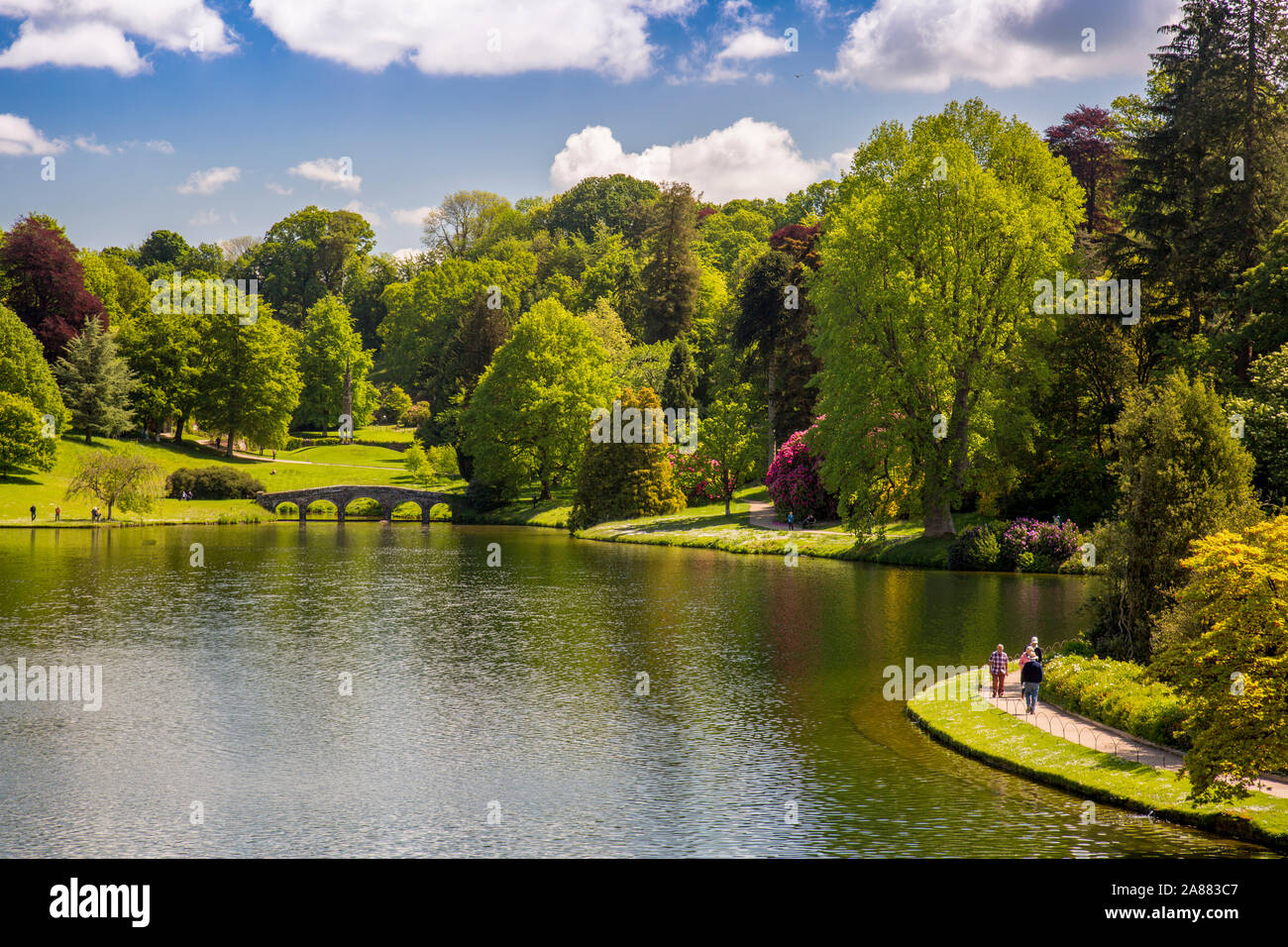 The Palladian Bridge and colourful rhododendron flowers in spring at Stourhead Gardens, Wiltshire, England, UK Stock Photo