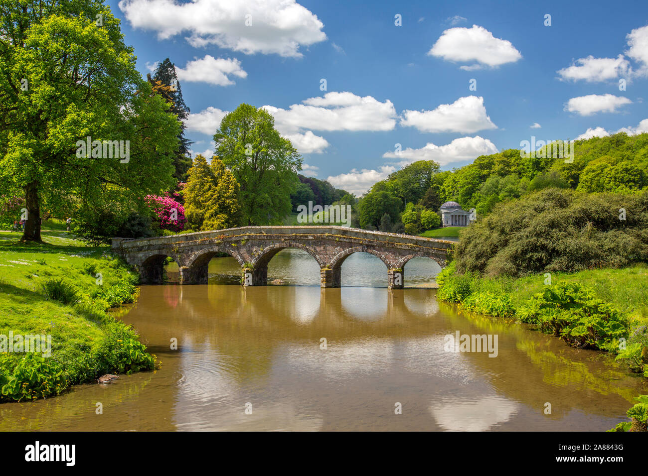 Looking across the lake with its Palladian Bridge towards the Pantheon at Stourhead Gardens, Wiltshire, England, UK Stock Photo