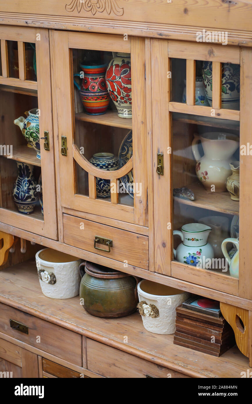 https://c8.alamy.com/comp/2A884MN/wooden-kitchen-cabinet-with-ceramic-plates-and-pots-in-kitchen-in-serbia-2A884MN.jpg